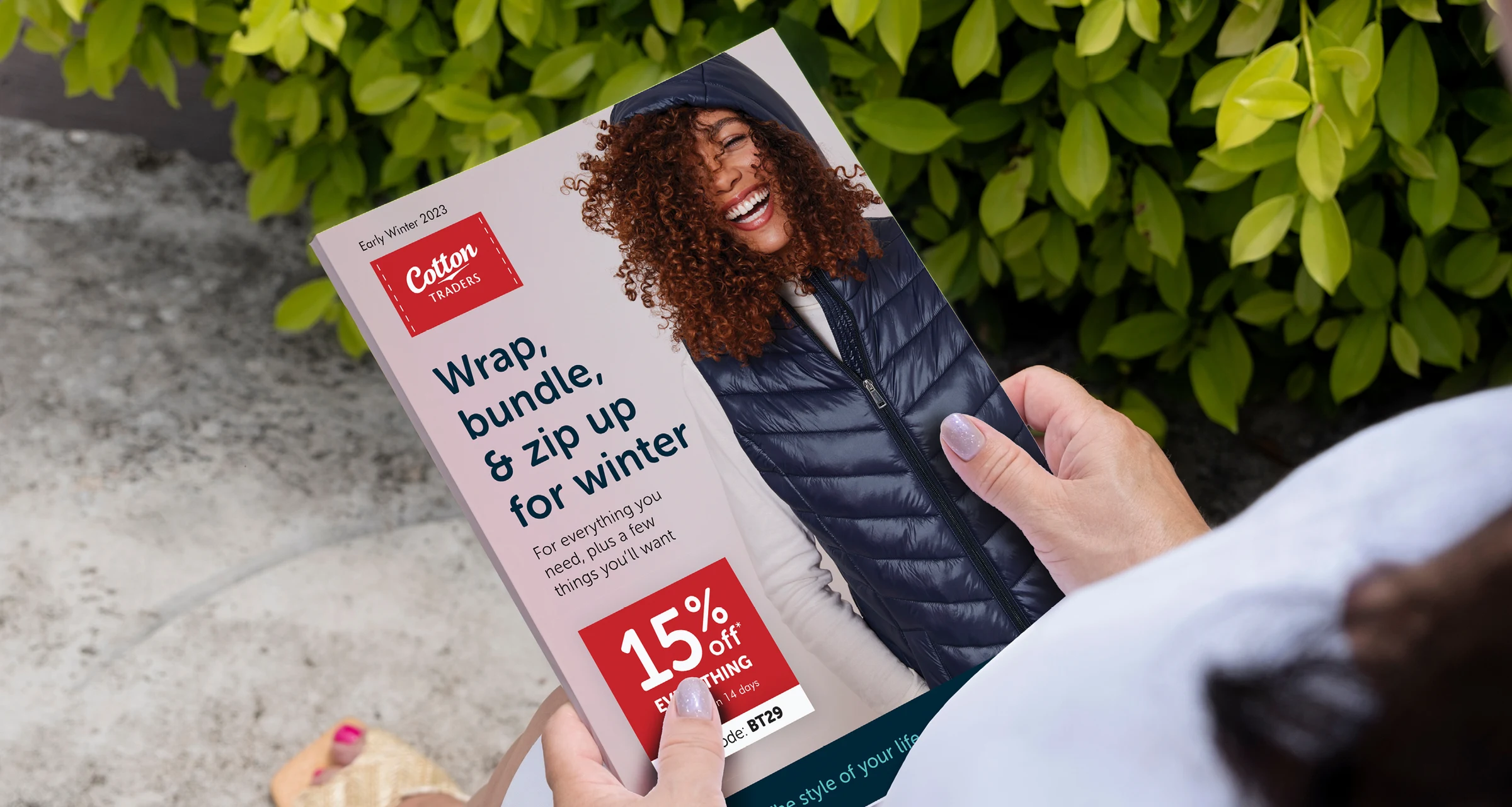 Cotton Traders' winter catalogue held up outdoors, open to the front cover